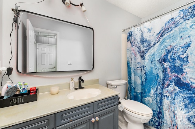 bathroom with toilet, vanity, and a shower with curtain