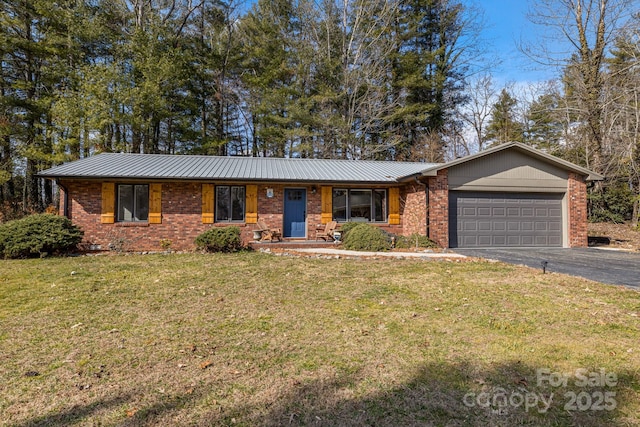 ranch-style home with a garage and a front lawn