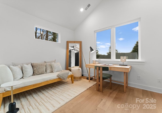 office space featuring light hardwood / wood-style flooring and high vaulted ceiling