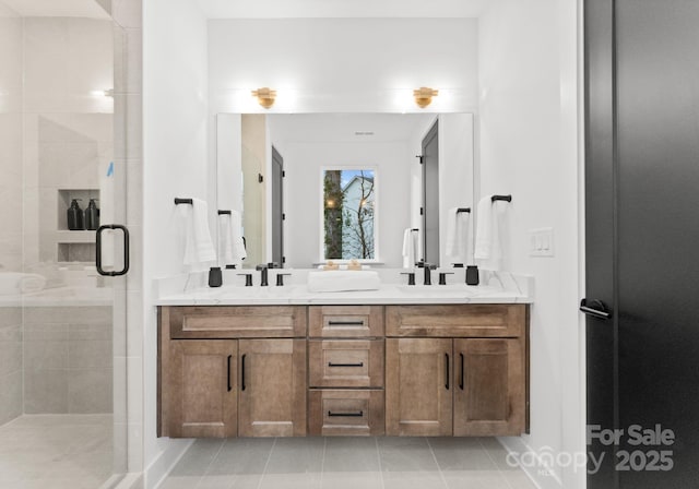 bathroom with tile patterned floors, vanity, and a shower with door