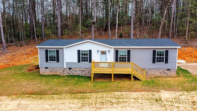 view of front facade with a front yard and a deck