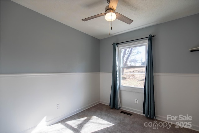 carpeted empty room featuring ceiling fan