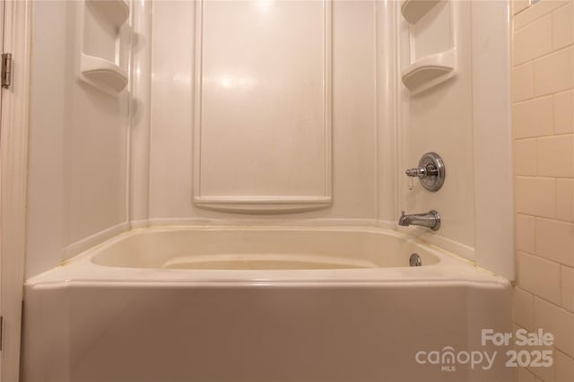 bathroom with shower / washtub combination