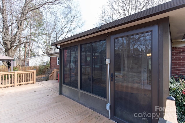 wooden deck featuring a sunroom