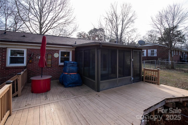 wooden deck featuring fence and a sunroom