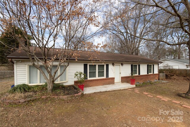 single story home featuring brick siding and fence