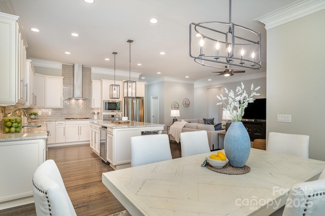 dining room featuring crown molding, ceiling fan, wood finished floors, and recessed lighting