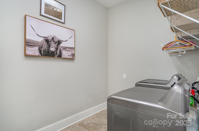 laundry room featuring laundry area, washing machine and dryer, and baseboards