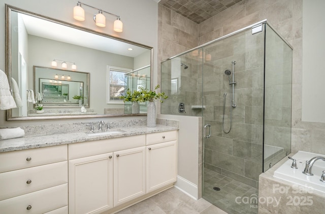 full bath featuring a stall shower, a garden tub, and vanity