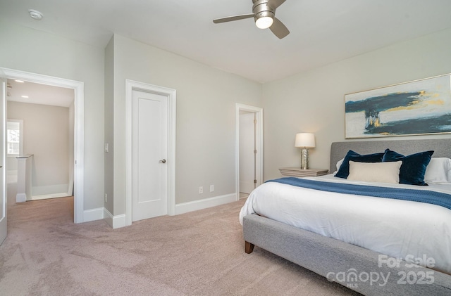 carpeted bedroom featuring ceiling fan and baseboards