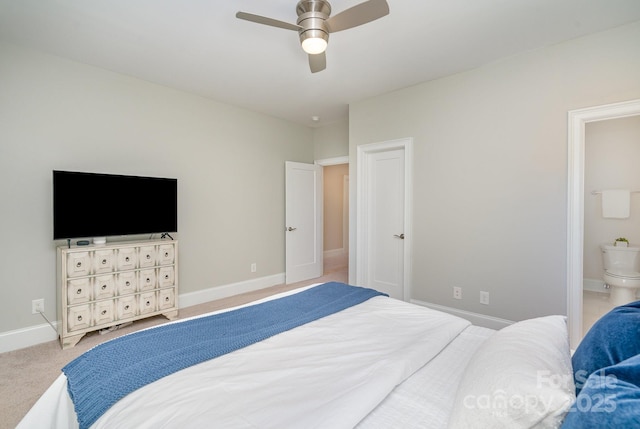 carpeted bedroom featuring ceiling fan, connected bathroom, and baseboards