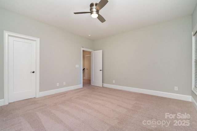 unfurnished bedroom featuring a ceiling fan, baseboards, and carpet flooring