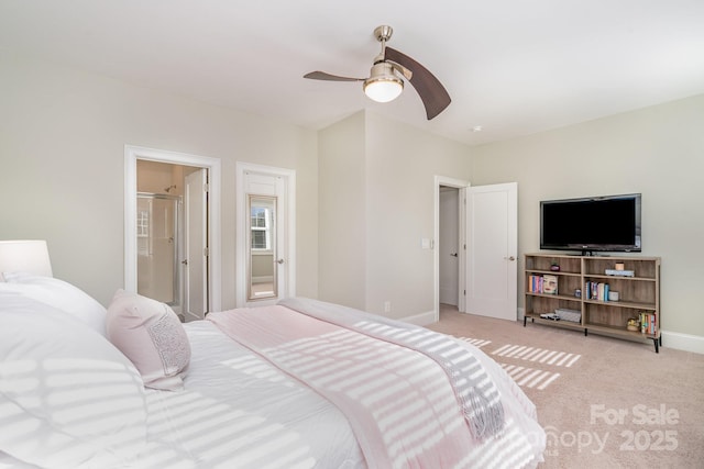 bedroom with baseboards, ensuite bath, a ceiling fan, and light colored carpet