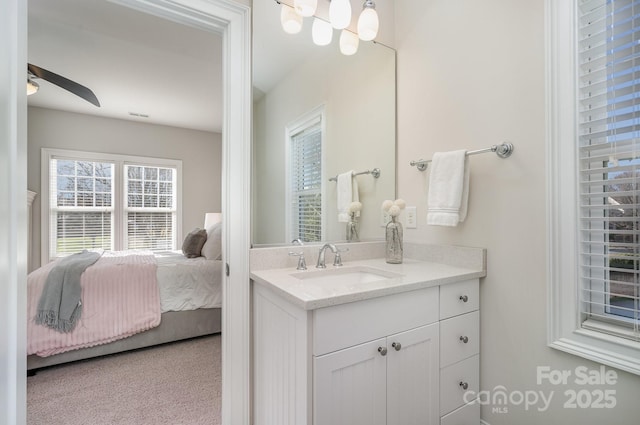 bathroom with visible vents, ensuite bath, vanity, and a ceiling fan