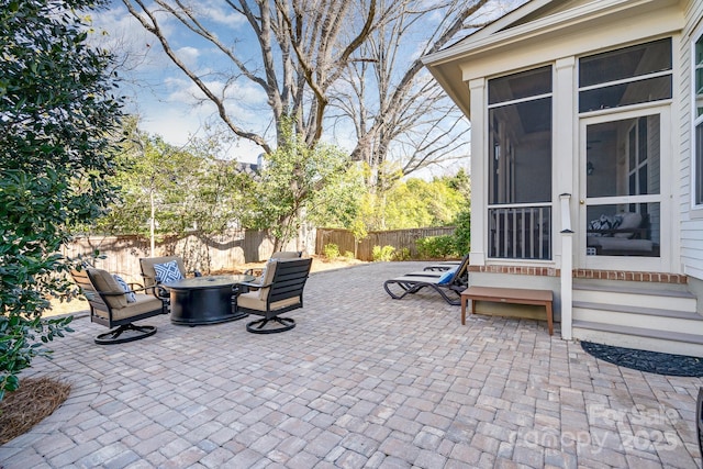 view of patio / terrace with entry steps, an outdoor fire pit, and a fenced backyard