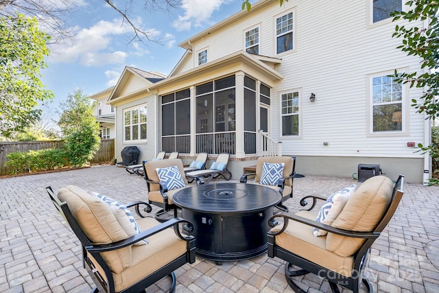 view of patio with a sunroom, fence, and an outdoor hangout area