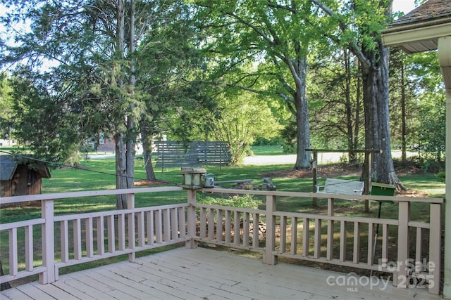 wooden deck featuring a yard