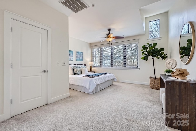 carpeted bedroom with multiple windows and ceiling fan