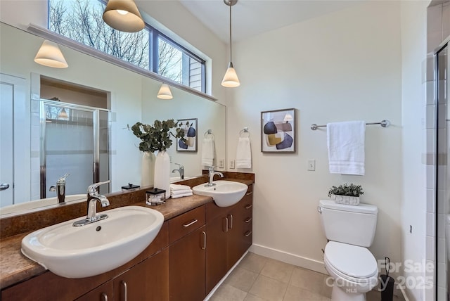 bathroom featuring walk in shower, vanity, toilet, and tile patterned flooring