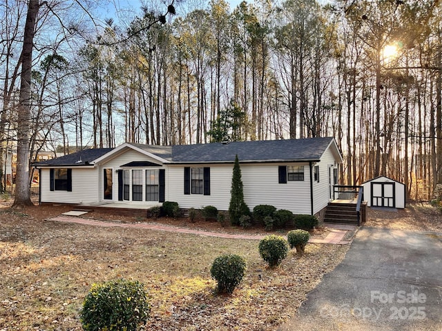 single story home with a shed