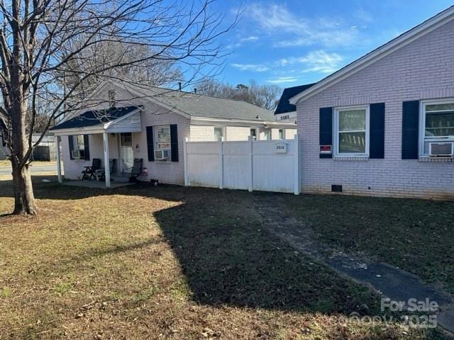 3516 The Plz, Charlotte, NC 28205 - view of property exterior featuring brick siding, crawl space, and cooling unit