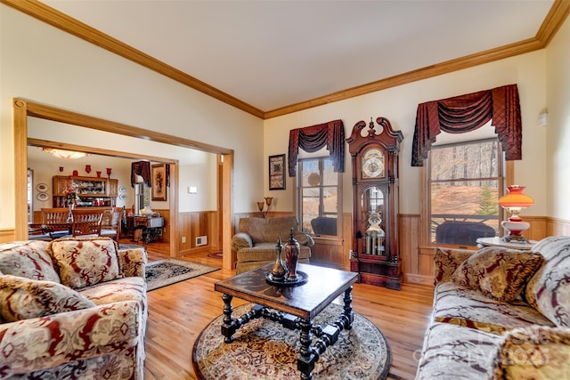 living room with crown molding and light hardwood / wood-style flooring