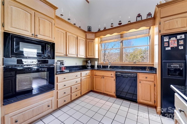 kitchen featuring light tile patterned floors, sink, light brown cabinets, and black appliances