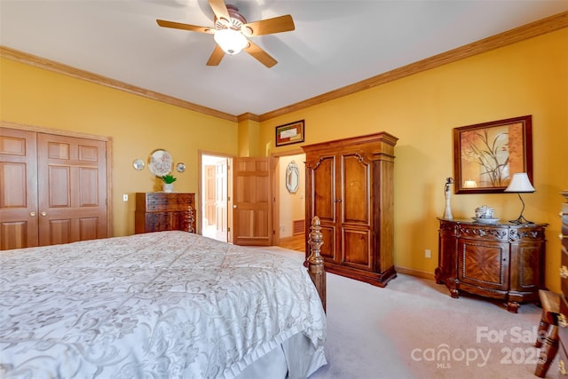 carpeted bedroom featuring crown molding, ceiling fan, and a closet