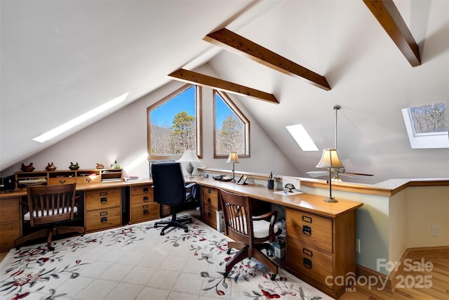 office featuring vaulted ceiling with skylight and ceiling fan