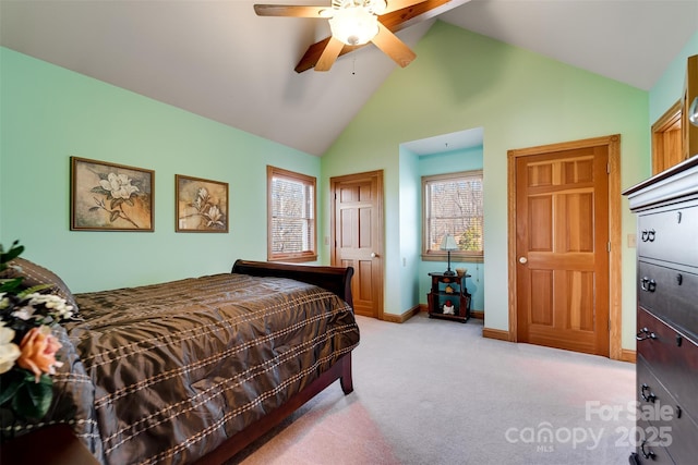 bedroom with ceiling fan, light colored carpet, and high vaulted ceiling