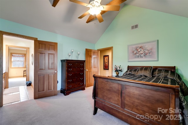 carpeted bedroom with ceiling fan and high vaulted ceiling