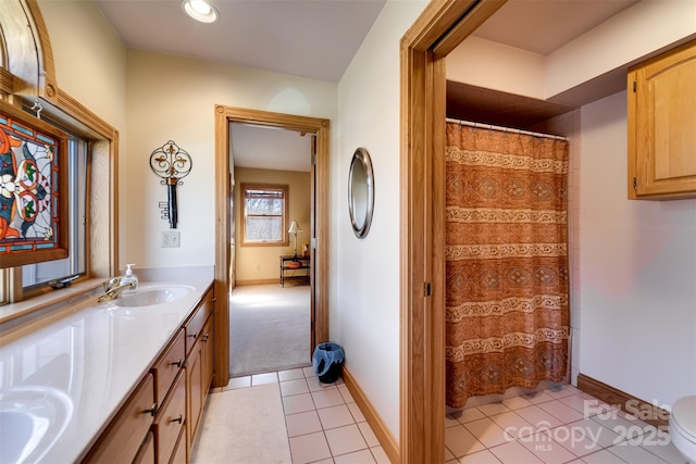 bathroom with tile patterned flooring, vanity, and toilet