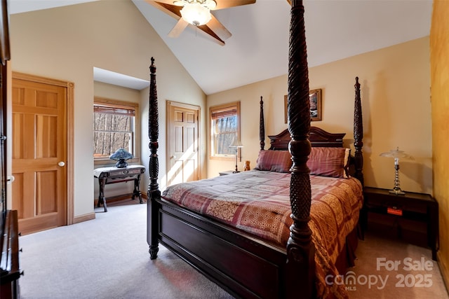 bedroom with multiple windows, vaulted ceiling, light colored carpet, and ceiling fan