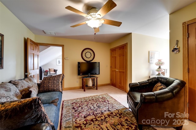 living room with light colored carpet and ceiling fan