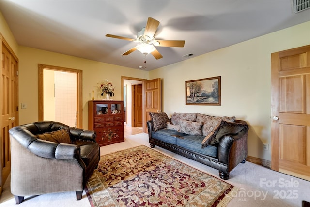 living room featuring light carpet and ceiling fan