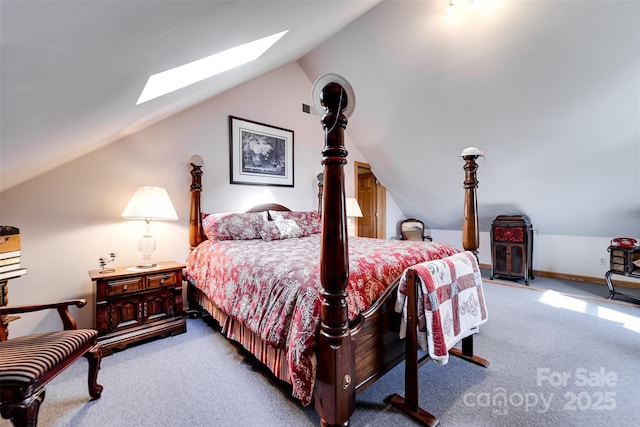 bedroom featuring lofted ceiling with skylight and light carpet