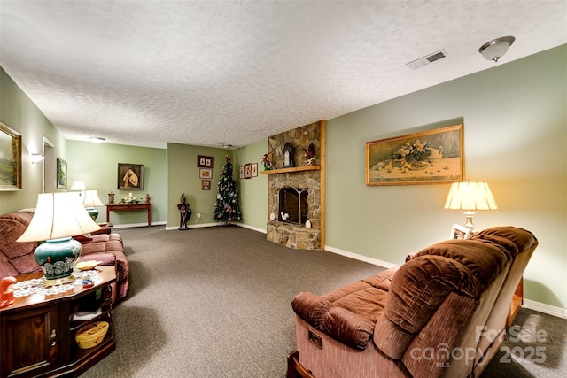 living room with a fireplace, carpet, and a textured ceiling