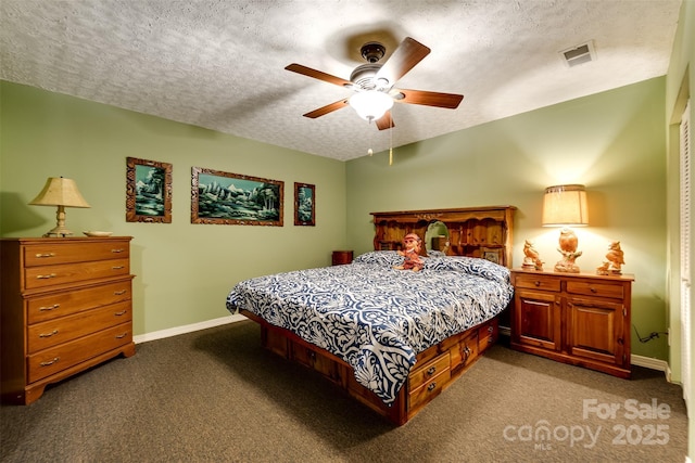 carpeted bedroom featuring ceiling fan and a textured ceiling