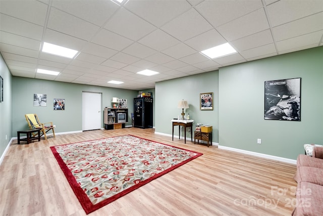 living room with a paneled ceiling and wood-type flooring