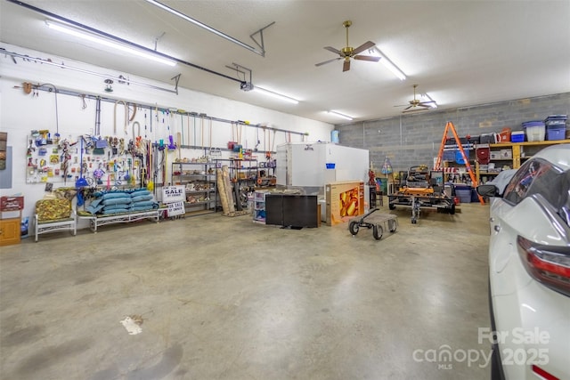 garage with ceiling fan, a garage door opener, and a workshop area