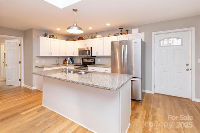 210 State St, Asheville, NC 28806 - kitchen with appliances with stainless steel finishes, white cabinetry, sink, hanging light fixtures, and a center island with sink