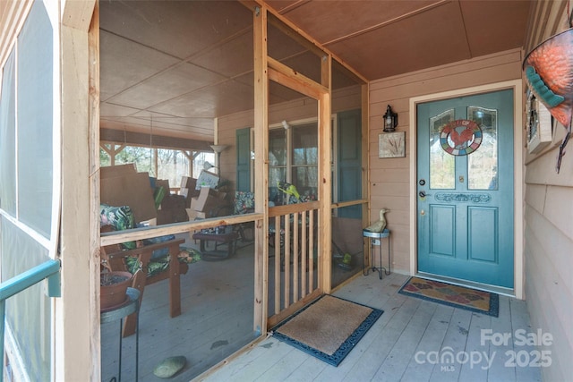 view of exterior entry with a porch