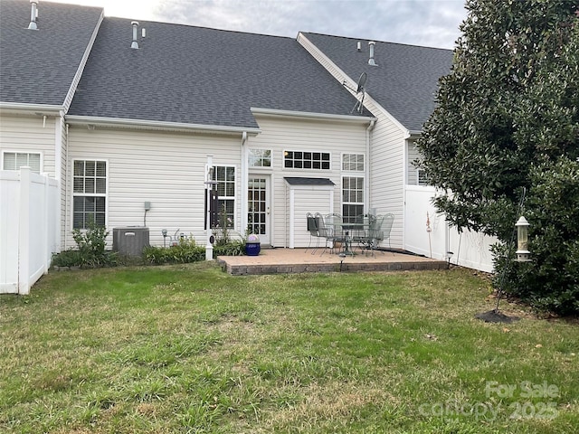 back of house with a yard, a patio area, and central AC