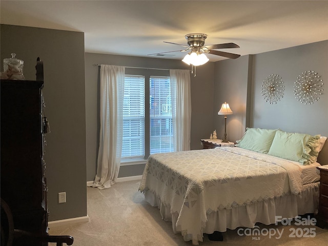 bedroom with ceiling fan and light carpet