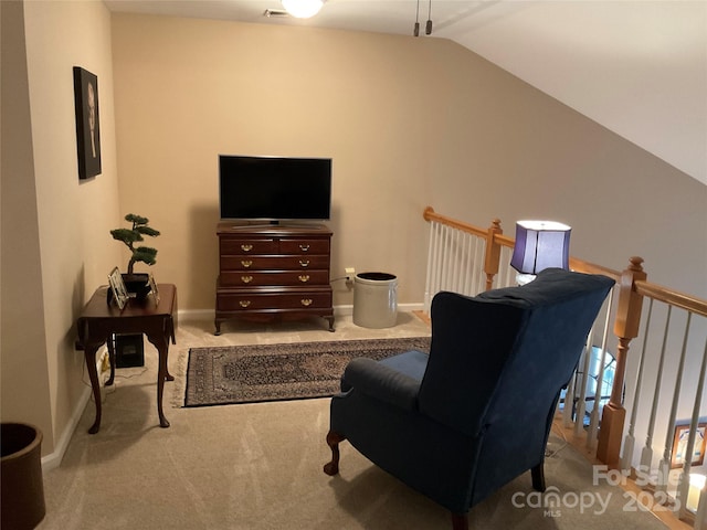 living area with lofted ceiling and light carpet