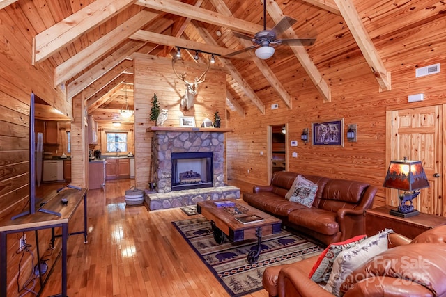 living room featuring wood-type flooring, wood ceiling, wooden walls, and beamed ceiling