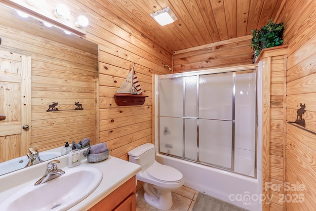 full bathroom featuring shower / bath combination with glass door, vanity, wooden ceiling, tile patterned floors, and toilet