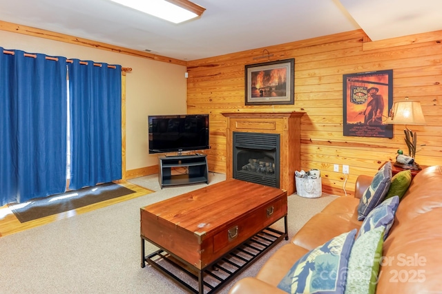 carpeted living room featuring wood walls