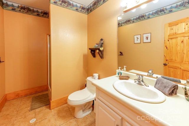 bathroom featuring tile patterned floors, vanity, and toilet