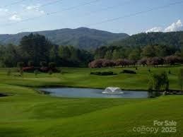 view of community with a water and mountain view and a lawn